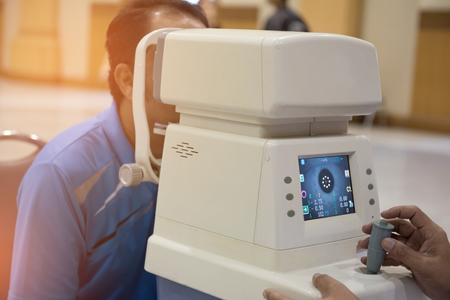 Acuity outings,Doctor controls instrument exploring patients eyeの写真素材