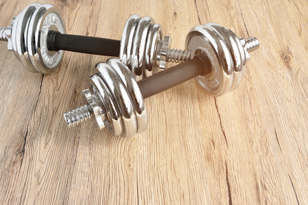 Dumbbells placed on Wood floor in the fitness roomの写真素材