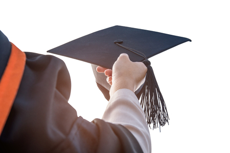 Graduates of the University,Of graduates holding hats handed on isolated backgroundの写真素材