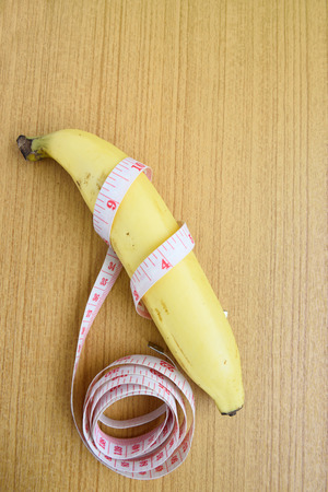 Gauge lines and bananas placed on wooden floor.の写真素材