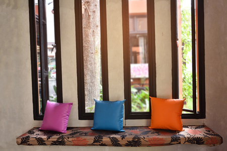 Three pillows resting on the sofa in the rest room.の写真素材