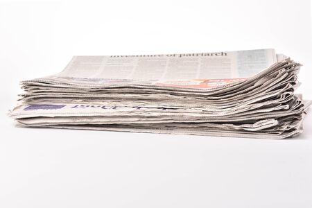 Stack newspaper pace on white isolated bakcgroundの写真素材