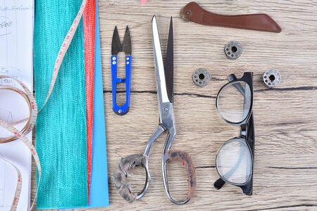 Fashion design ,Tools for sewing on wooden background Top view.の写真素材