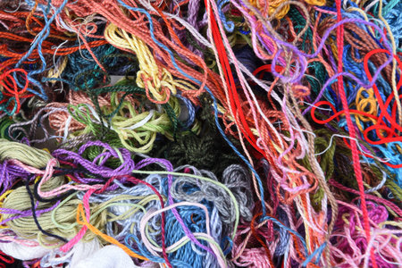 Fashion design multicolor sewing threads on wooden background