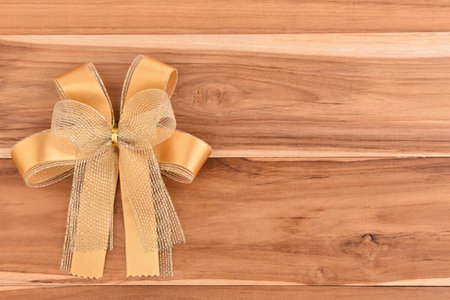 Gold gift stick pace on wooden background