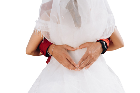 Wedding couples embrace heart-shaped symbols on isolated backgroundの写真素材