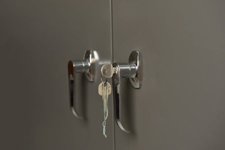Closeup Gray steel Storage Cabinets with the key in office.