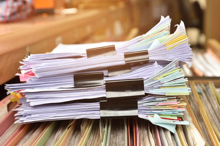 Stack Document file and black PaperClip pace on Cabinet in office.の写真素材