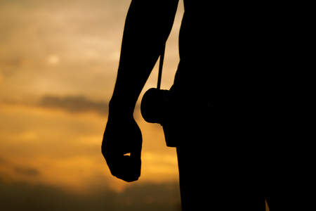 Silhouette Sunset,Photographer checks camera files.の写真素材
