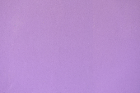 Purple paint roller on the white wall.の写真素材