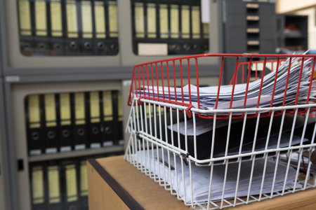 Files stack on the desk in the office.