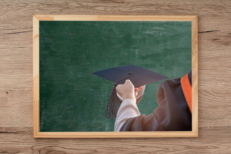 Blackboard on wooden floor,Graduates are in the picture.の写真素材