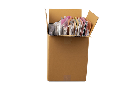 The documents and files are placed in a brown box on the table.の写真素材