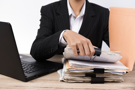Office worker handles documents on the desk.の写真素材
