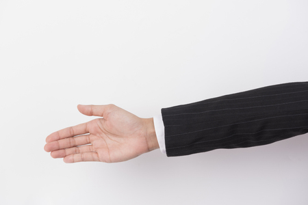 The hand of a businessman extends on white isolated background.の写真素材