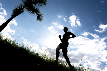 Men running outdoor on silhouette background.の写真素材