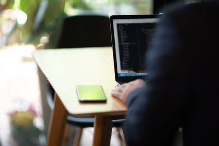 Businessmen use laptop computers connected to the Internet.