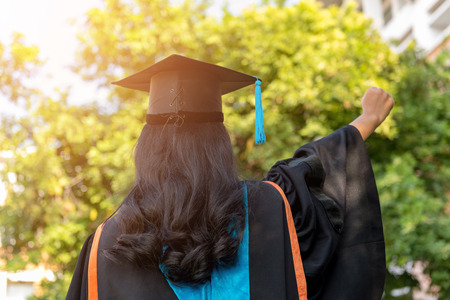 Graduated young girl wearing a black tassel hat.の写真素材