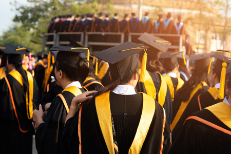 Graduates wear black hats, black hats.Graduates join the graduation ceremony at the university.の写真素材