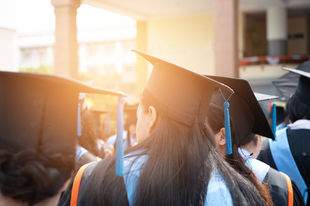 Graduates wear black hats, black hats.Graduates join the graduation ceremony at the university.の写真素材