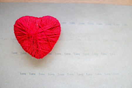Red heart placed on the old paperの写真素材