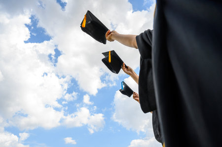 Graduates throw hats on graduation day at the university.
