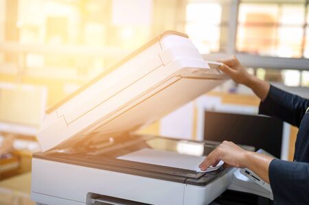 Office staff photocopying at the document makerの写真素材