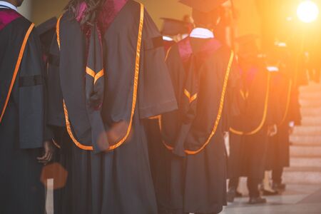 Graduates receive a certificate at a university diploma ceremony.の写真素材