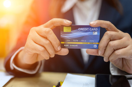 Working women holding credit cards at the office