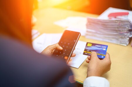 Working women holding credit cards at the officeの写真素材