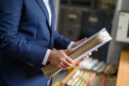 Working women manage to find office documentsの写真素材