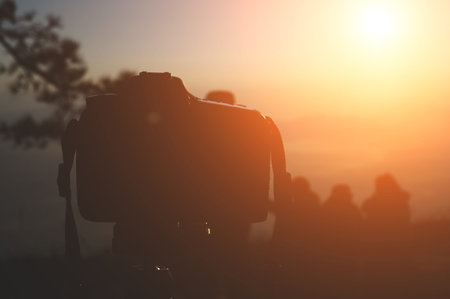 A male photographer travels and shoots landscapes at sunset