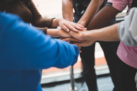 Large group of businessmen join hands for business cooperationの写真素材