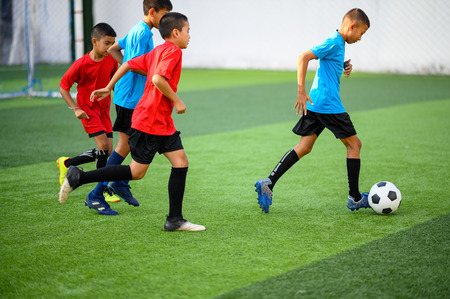 Boys playing football on the football practice fieldのeditorial素材