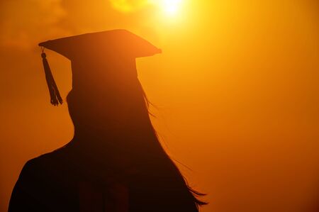 abstract Close up Rear view of the university graduates at Silhouette sunsetの写真素材