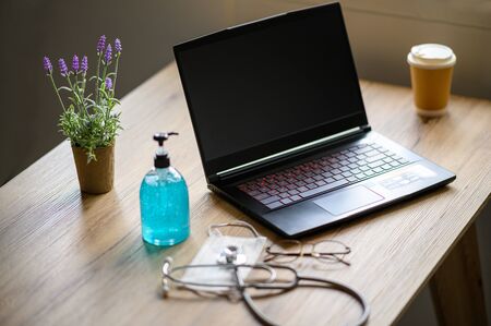 People are working at home because of the epidemic and there is alcohol for cleaning.の写真素材