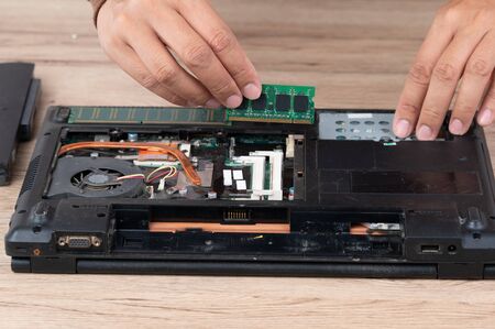 The laptop computer was dismantled to repair internal equipment.の写真素材