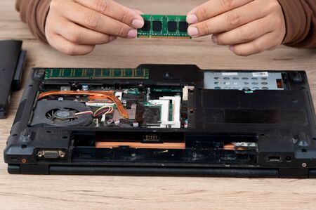 The laptop computer was dismantled to repair internal equipment.の写真素材