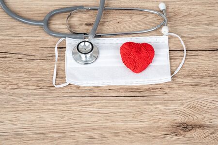 Stethoscope and red heart pace on the desk,Heart disease concept.の写真素材