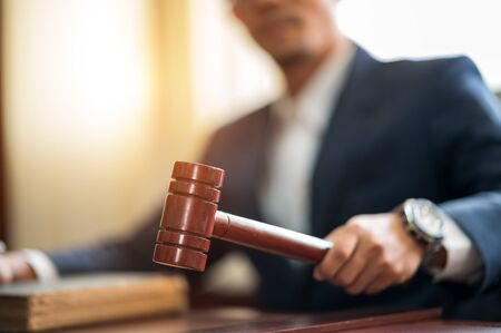 Judge held Wooden Hammer for Adjudge Judicial of Lawyer In the courtroomの写真素材