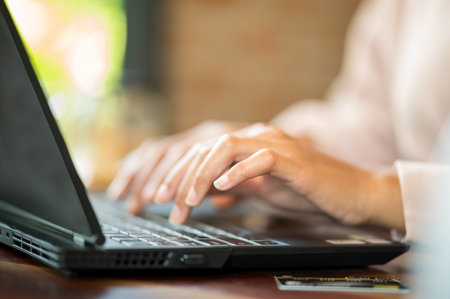 close up Woman in cafe shopping online with laptop