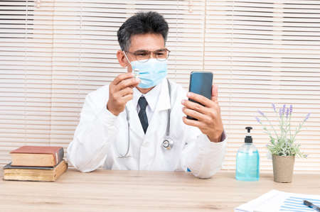 Portrait male doctor wearing a mask with isolated backgroundの写真素材