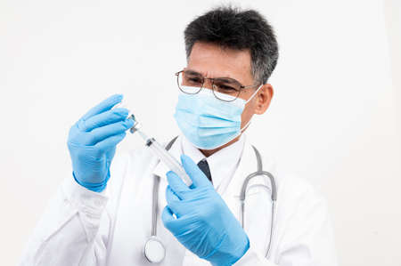 Portrait male doctor wearing a mask with isolated backgroundの写真素材