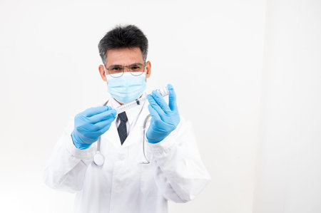 Portrait Male doctor holding a syringe and vaccine bottle with isolated background