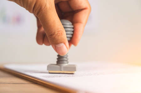 Close-up Of rubber stamp for Approved document At Deskの写真素材