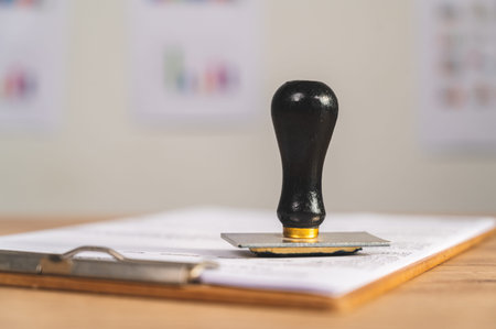 Close-up Of rubber stamp for Approved document At Deskの写真素材