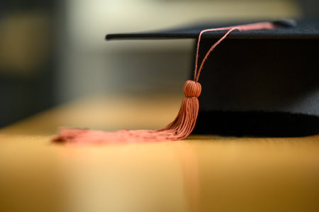 Close up hand of Graduate holding Graduation hat on the green chalkboard background,Education Success Conceptの写真素材