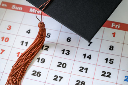 PhD graduate in black graduatio gown University degreeの写真素材