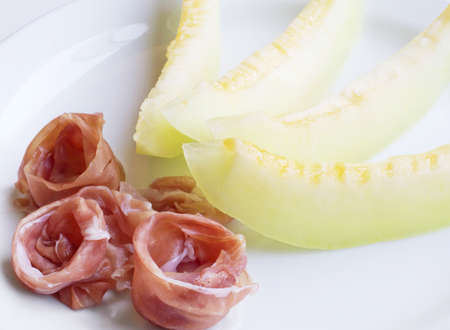 Close-up of a delicious and fresh sliced melon with ham の写真素材