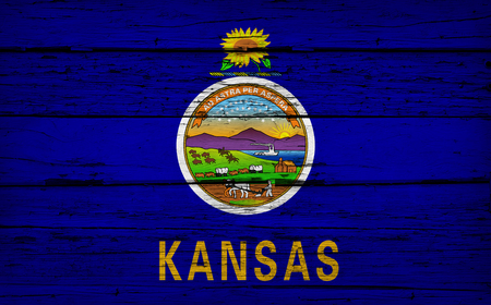 Kansas US State grunge wood background with Kansan flag painted on aged wooden wall.の写真素材